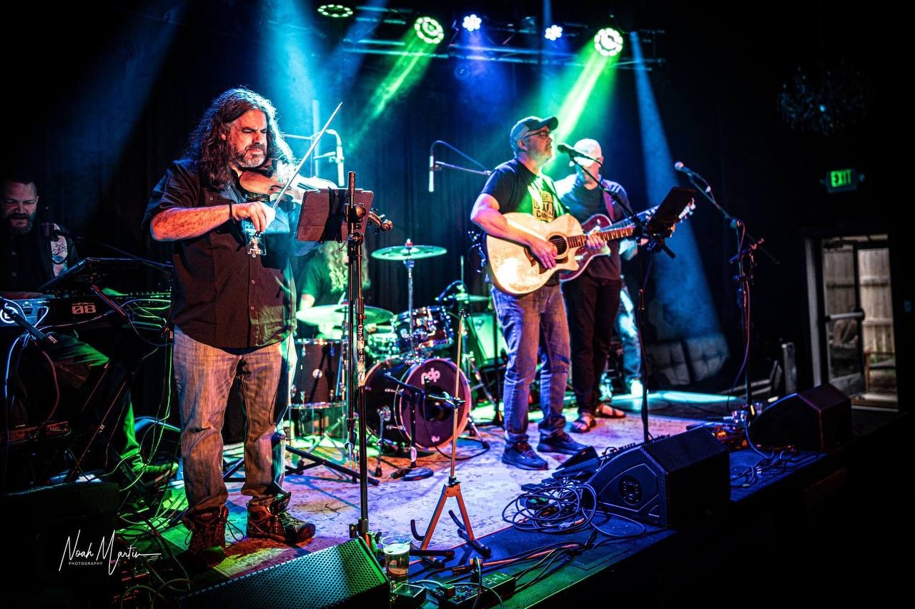 Full band performing on a club stage