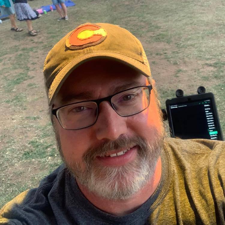 Lance smiling in a Colorado cap